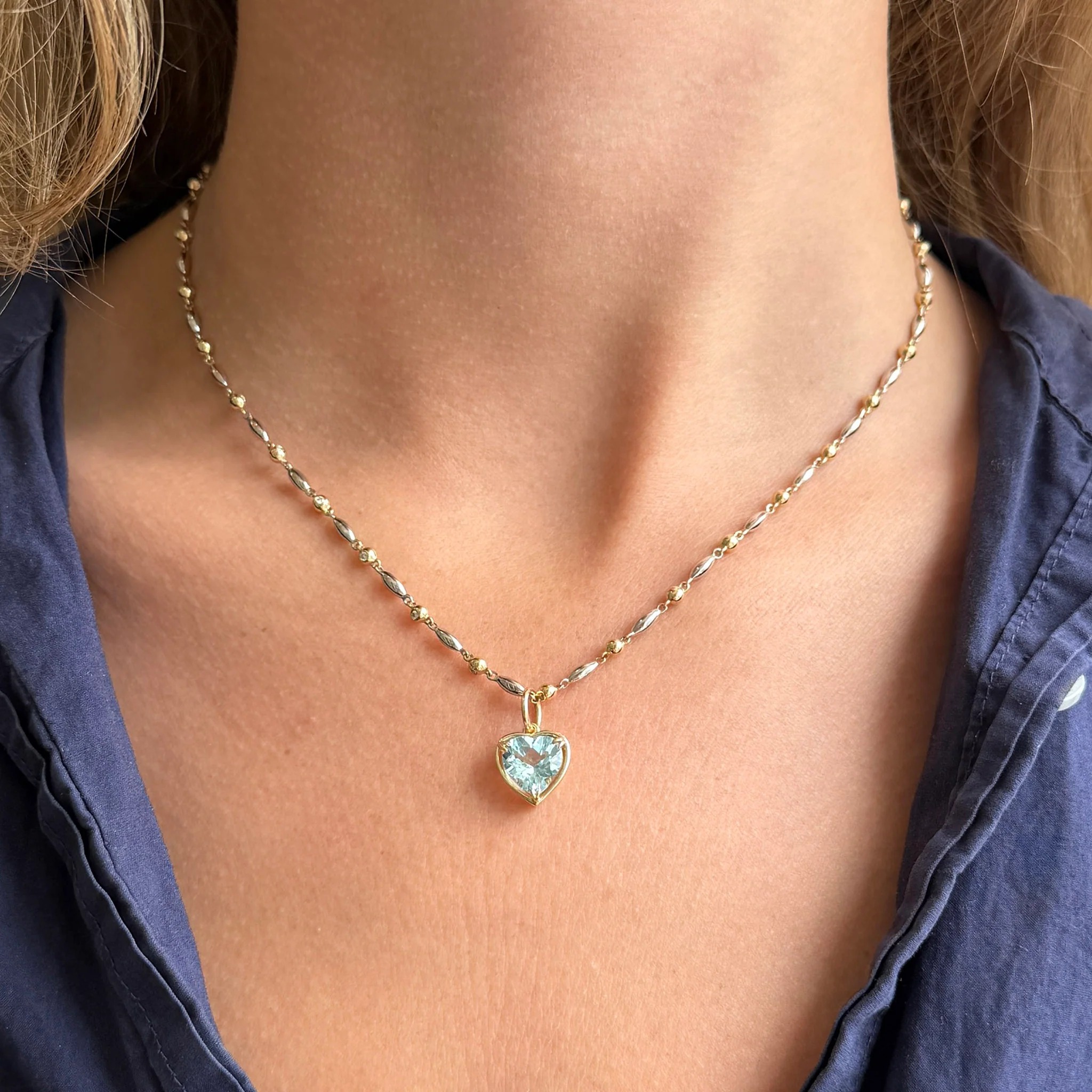 silver pendant on gold chain